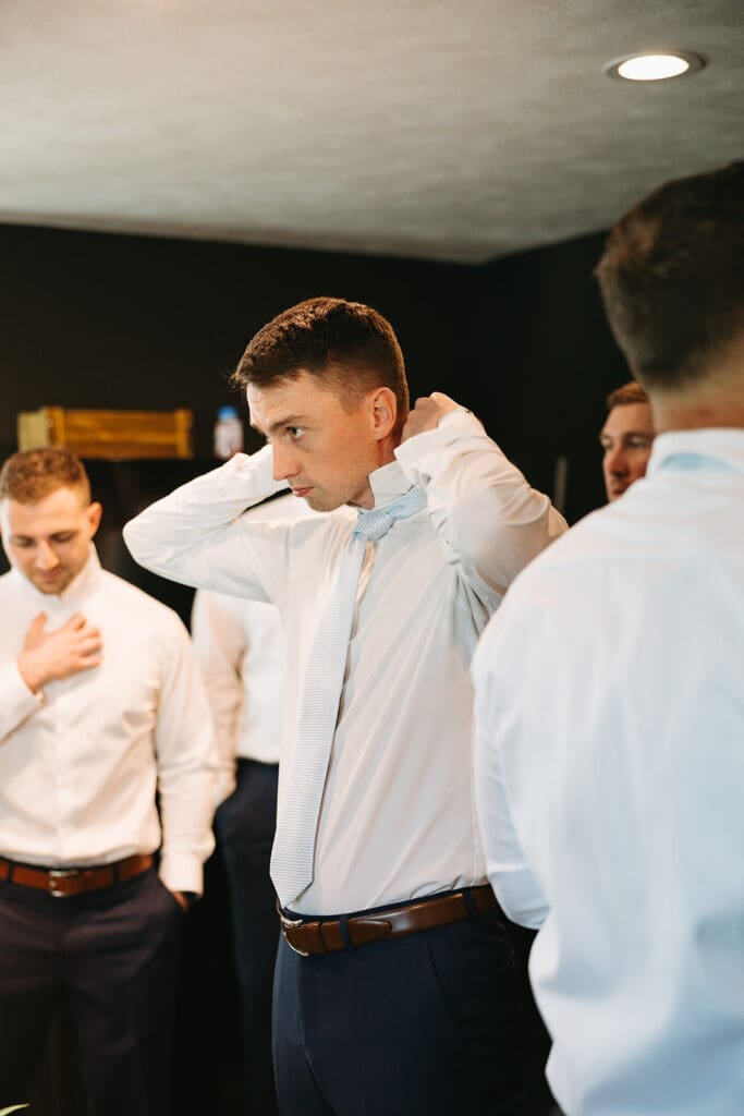 Groom getting ready for his wedding in Wichita wedding venue.