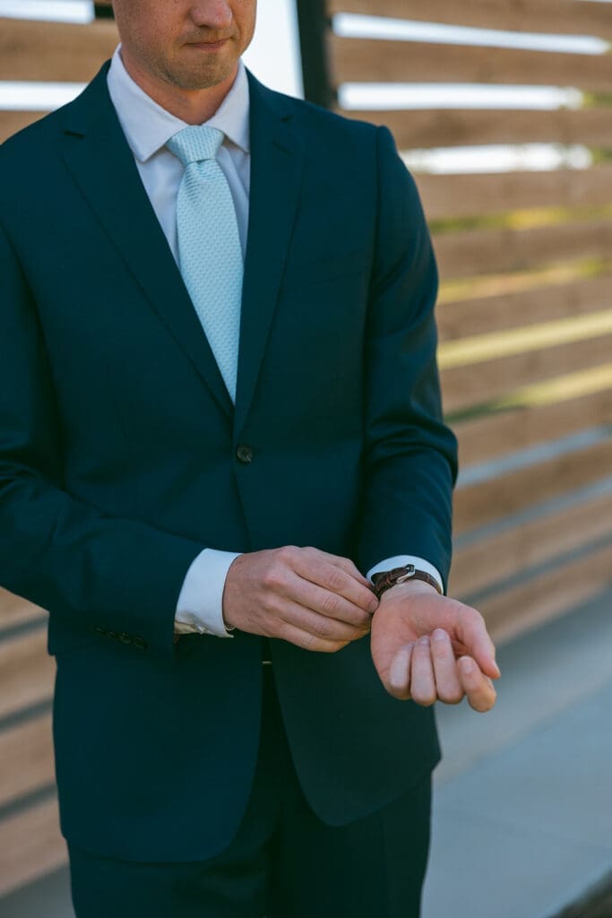Groom getting ready for his wedding in Wichita wedding venue.