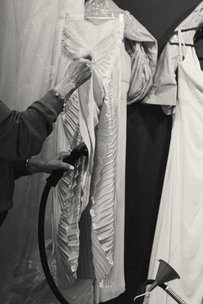 Mother of the bride steaming wedding dress.