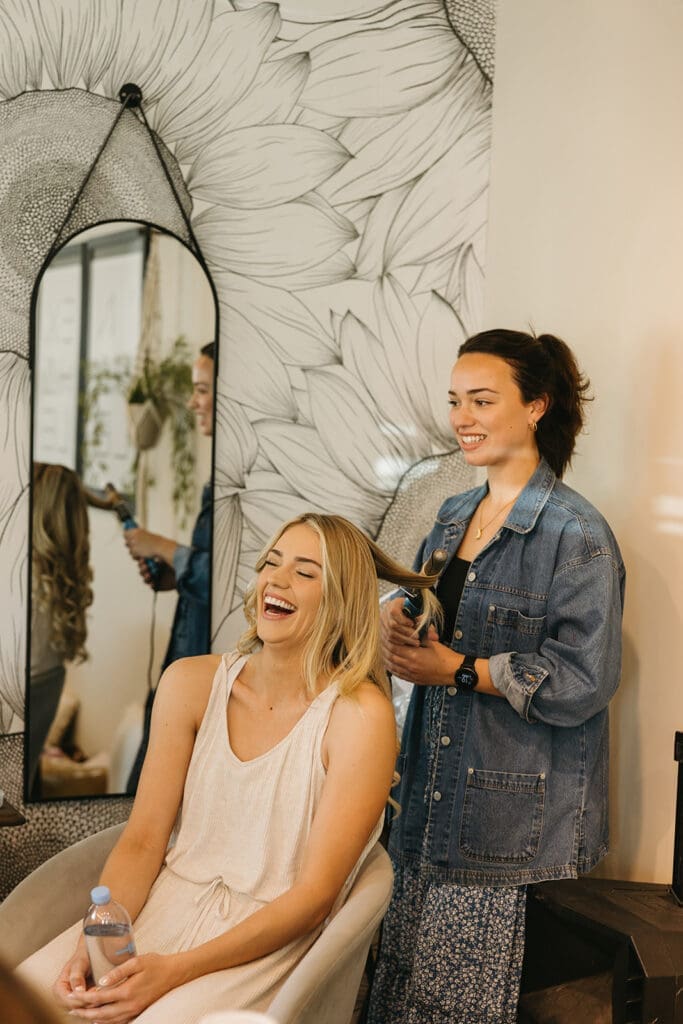 Bride gets hair curled in Wichita, KS wedding venue.