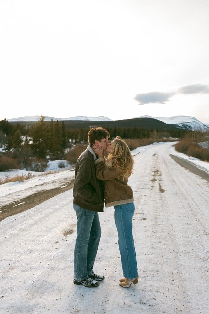 engagement photos taken in breckinridge colorado with a snowy mountain background