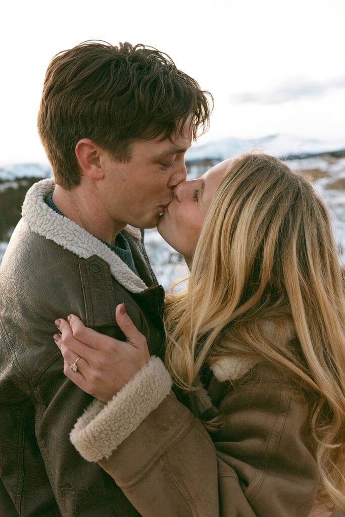engagement photos taken in breckinridge colorado with a snowy mountain background