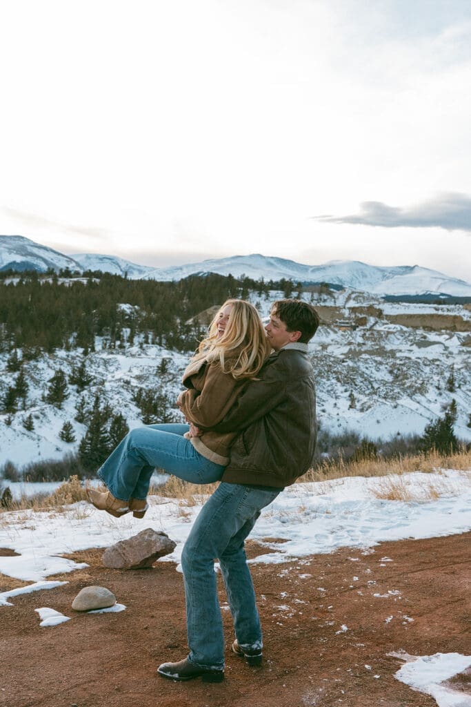 engagement photos taken in breckinridge colorado with a snowy mountain background