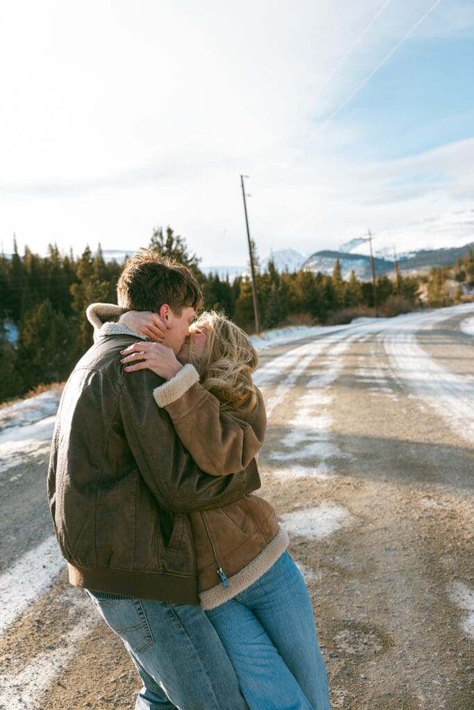 engagement photos taken in breckinridge colorado with a snowy mountain background