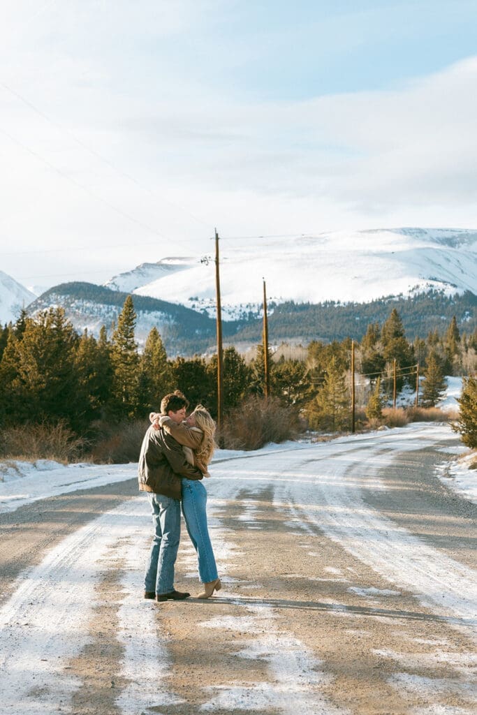 engagement photos taken in breckinridge colorado with a snowy mountain background