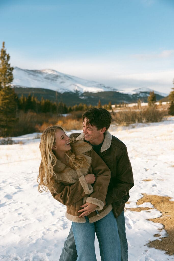 engagement photos taken in breckinridge colorado with a snowy mountain background