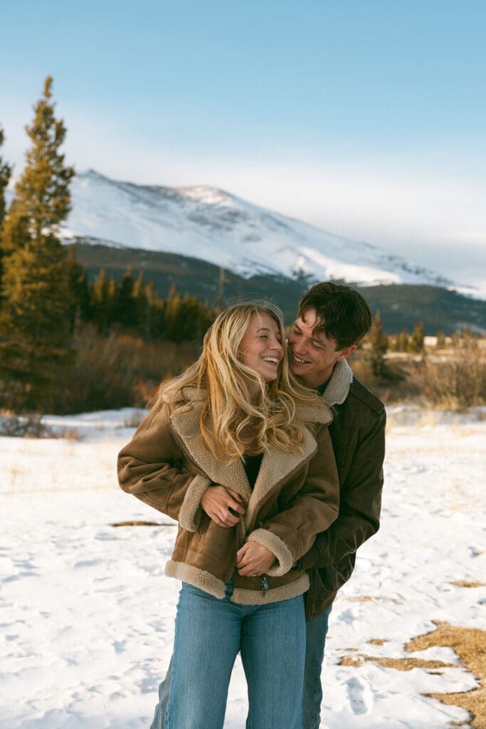 engagement photos taken in breckinridge colorado with a snowy mountain background