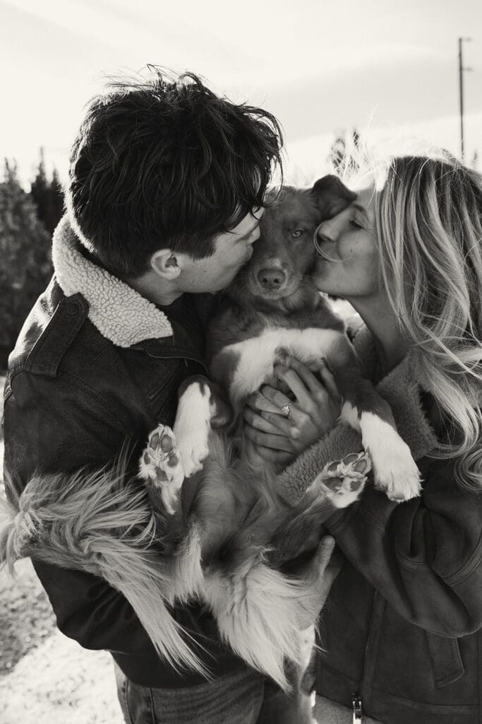 engagement photos taken in breckinridge colorado with a dog and a snowy mountain background