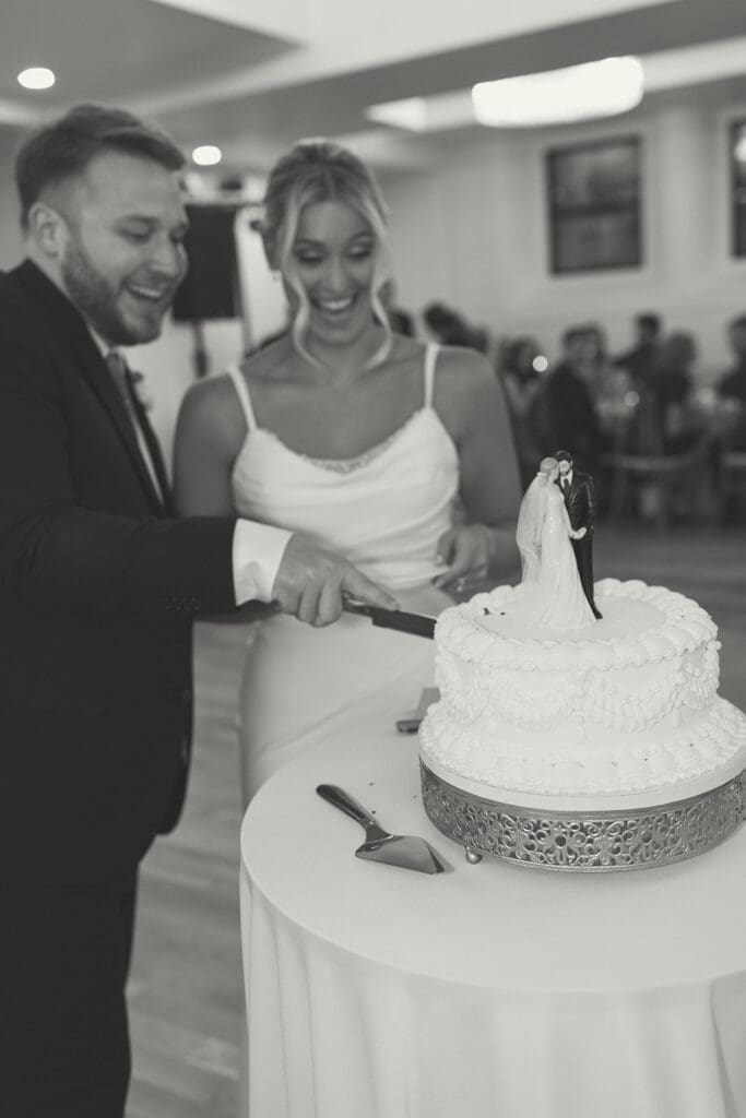bride and groom cutting cake in melrose abbey in kansas city