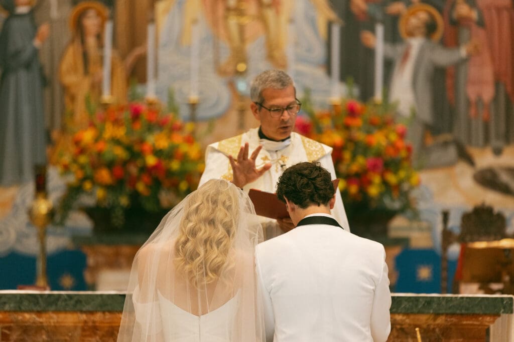 bride and groom at altar in elegant catholic ceremony in kansas city