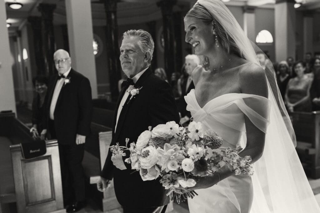 Bride walking down aisle in elegant catholic ceremony in kansas city