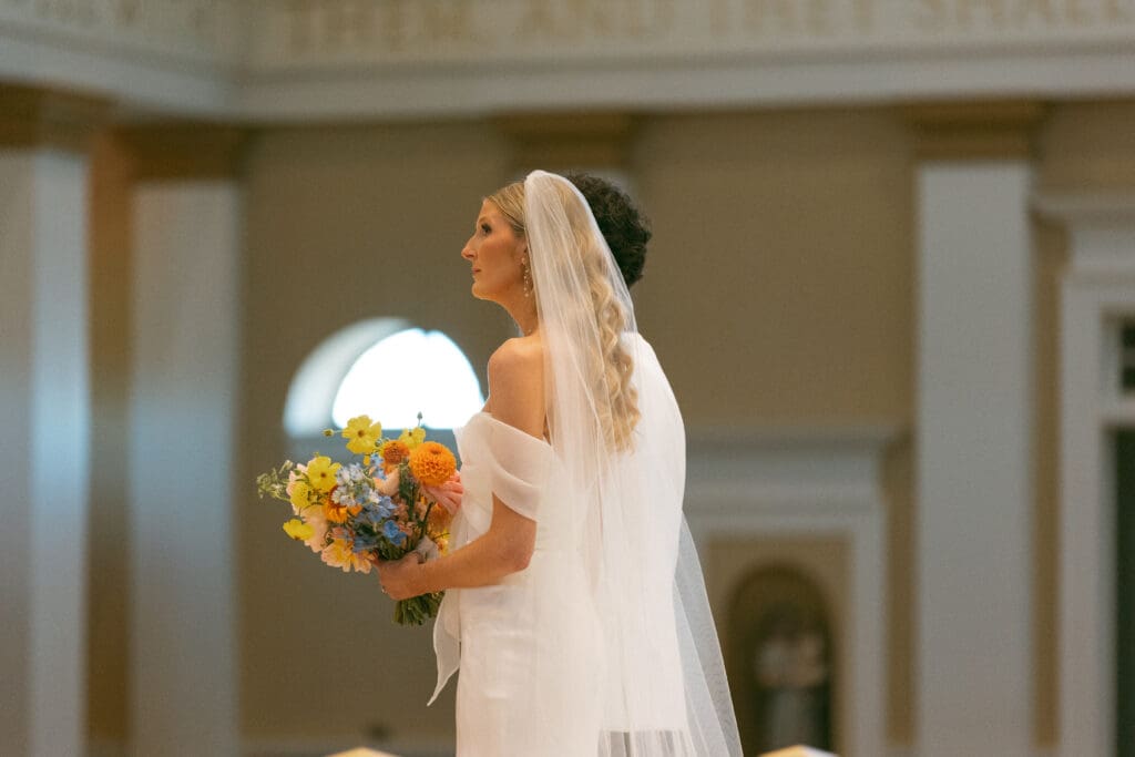 bride and groom at altar in elegant catholic ceremony in kansas city