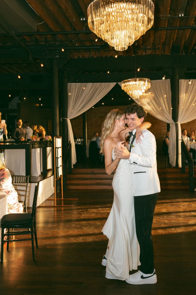 bride and groom dancing in colorful, luxurious wedding reception in kansas city