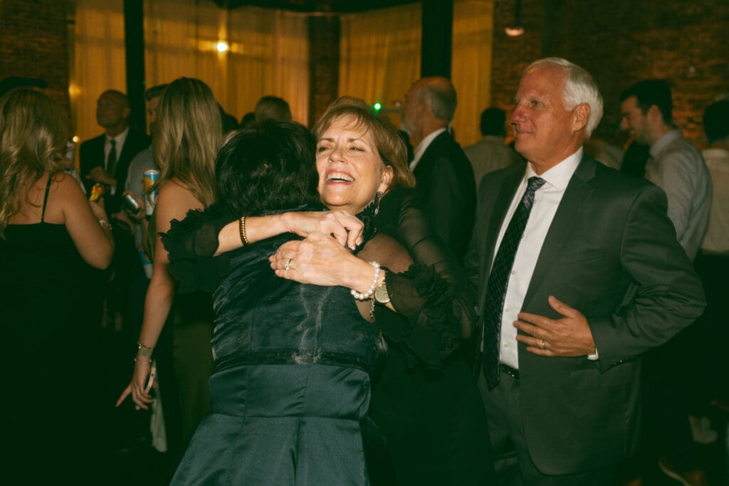 friendly hug at elegant, luxurious, colorful reception in kansas city