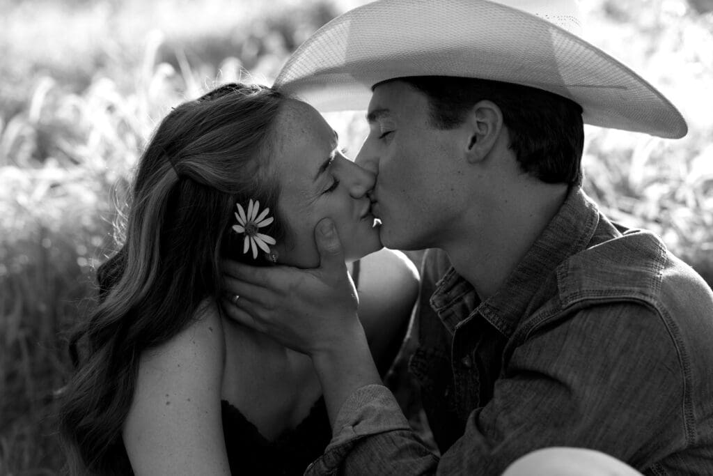 woman and man kissing during engagement session in kansas city