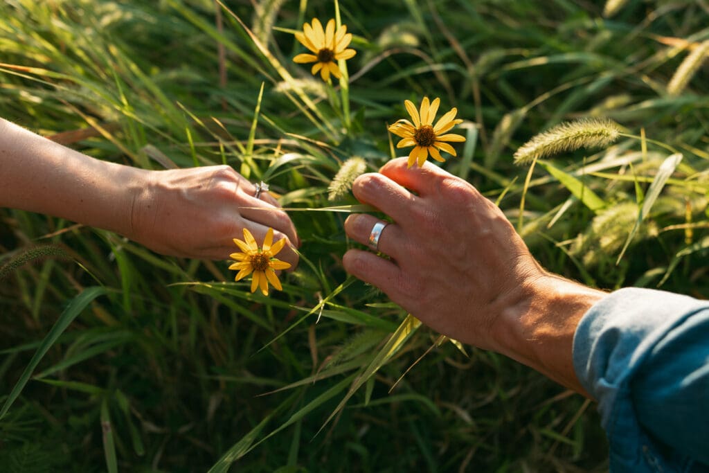 close up of hands and flowers during engagement session in kansas city