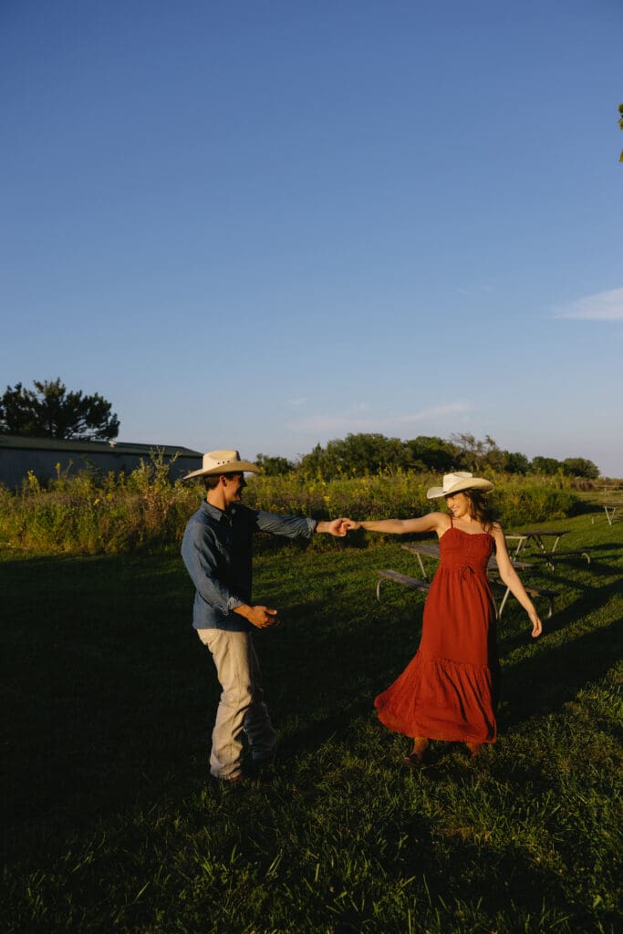 woman and man dancing during engagement session in kansas city