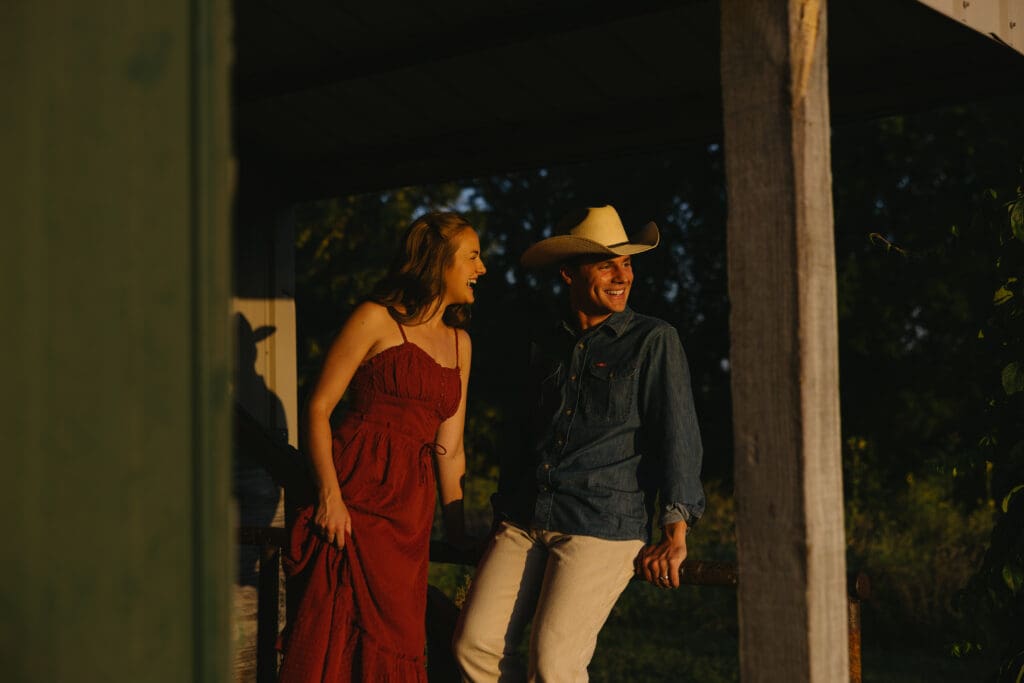 woman and man laughing during engagement session in kansas city