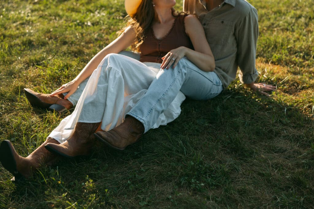 close up of woman and man laying in field during engagement session in kansas city