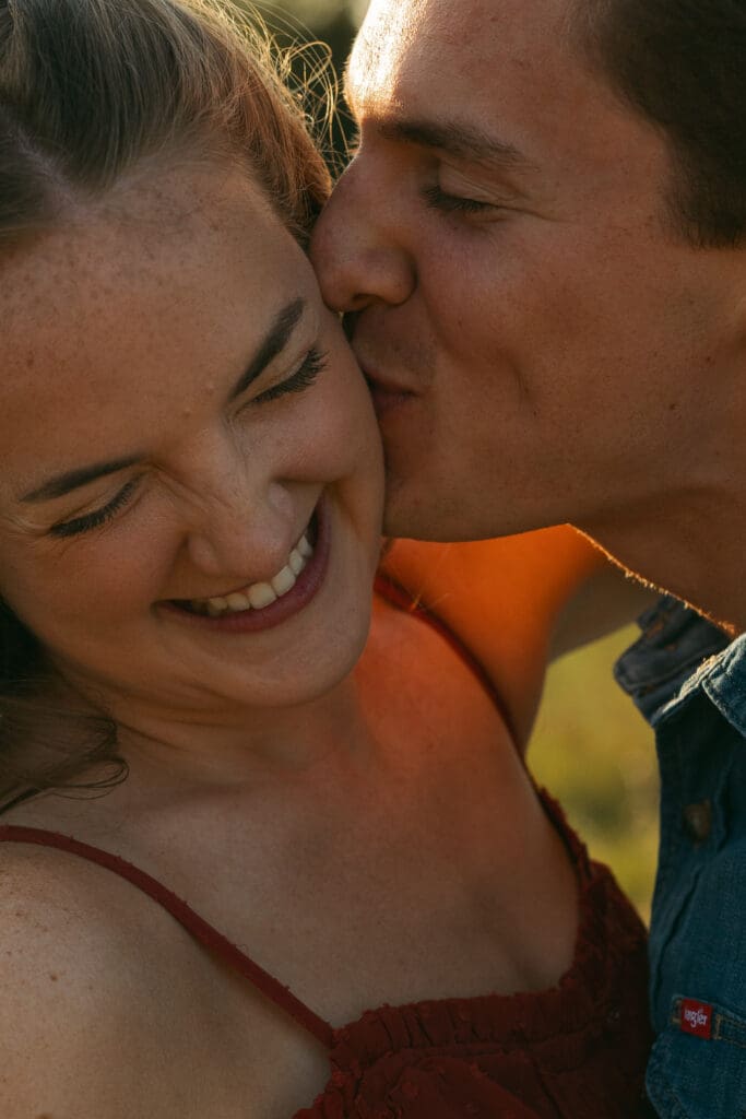 woman and man laughing during engagement session in kansas city